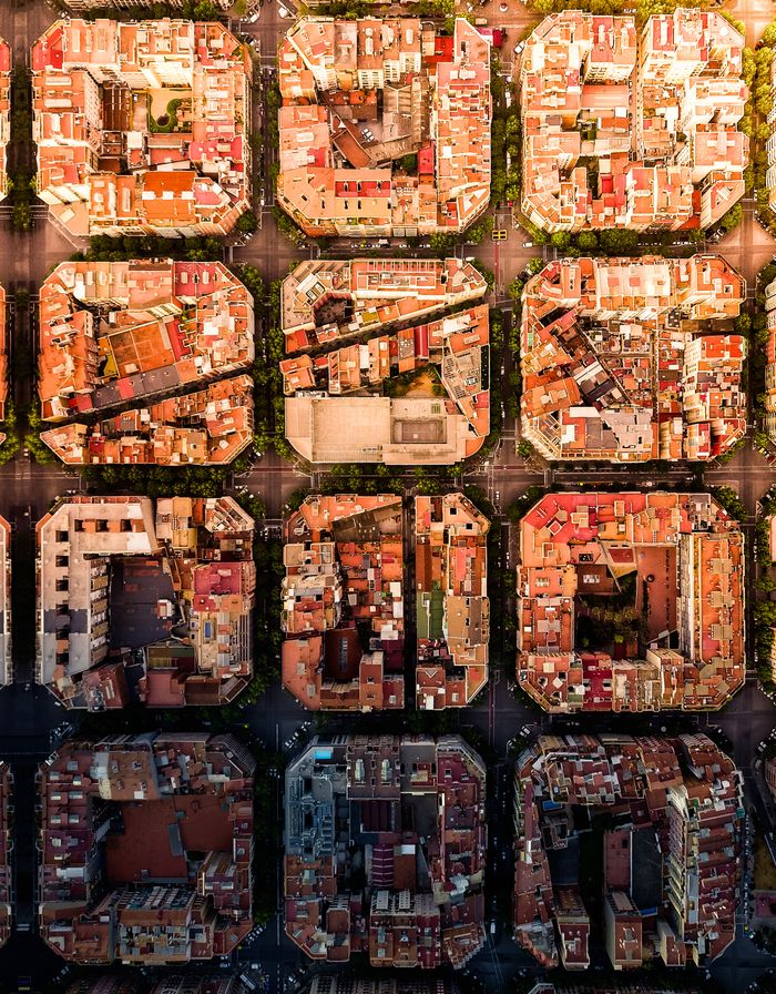 Drone shot of the iconic Eixample district grid pattern in Barcelona, Spain.